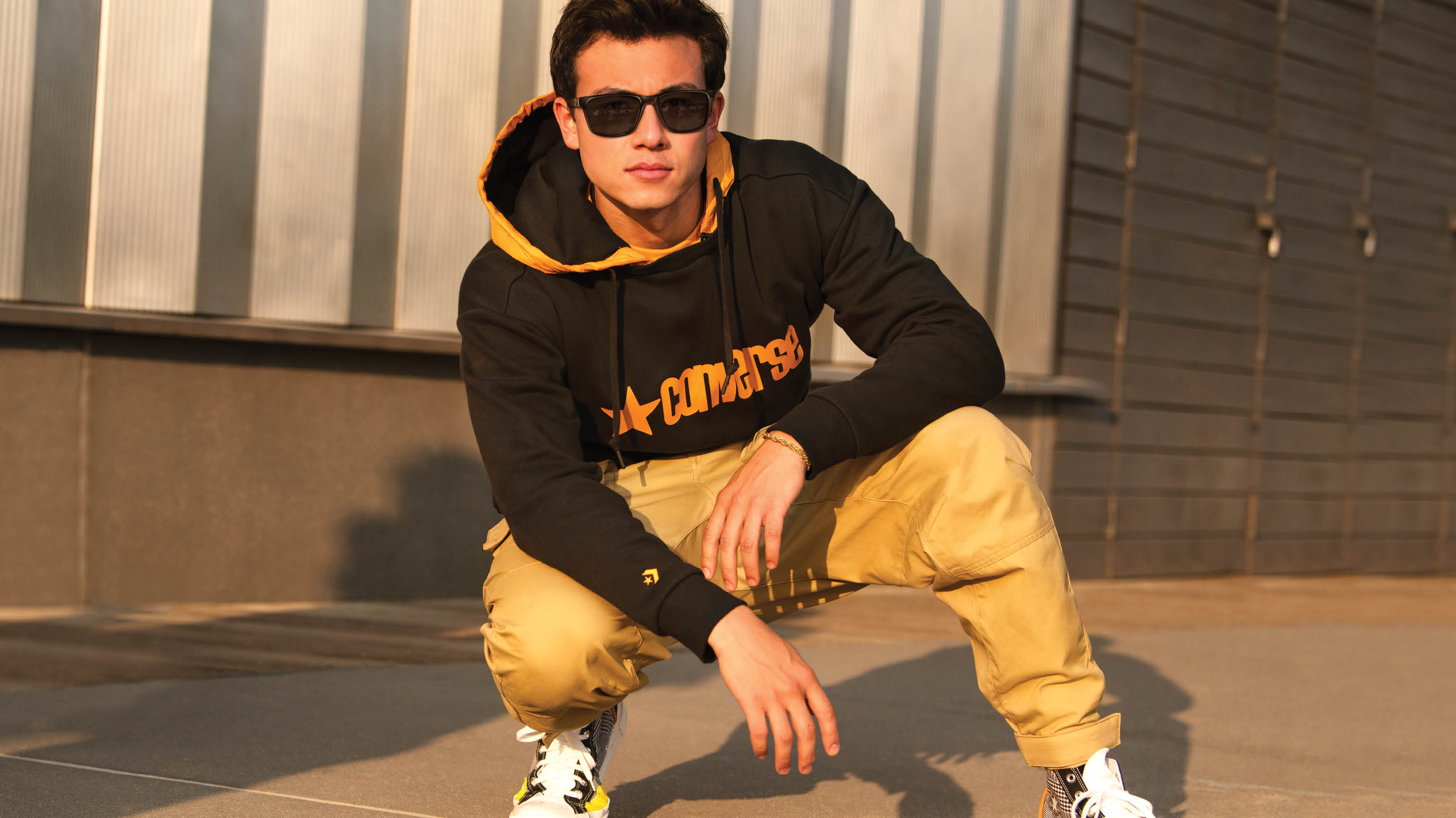 Model wearing yellow shirt and Converese glasses