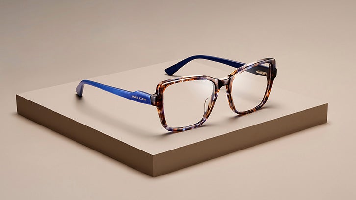 Tortoiseshell eyeglasses displayed on a neutral pedestal.