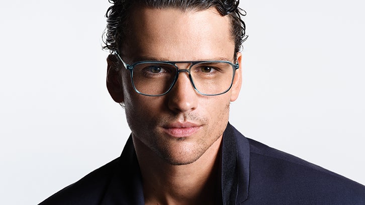 Male model wearing blue Calvin Klein eyeglasses