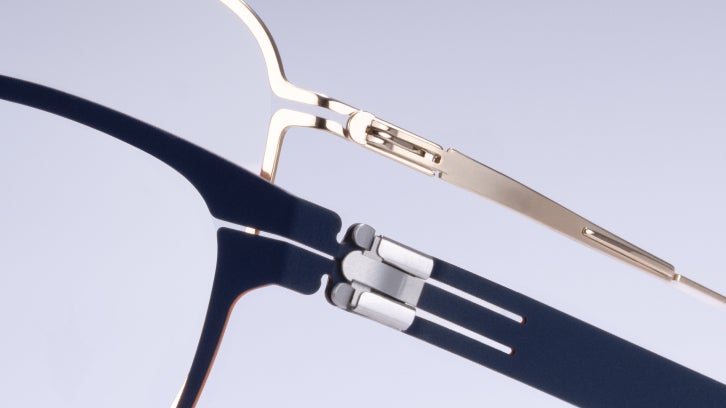 Close-up of gold and navy ic! berlin eyeglass temple hinges