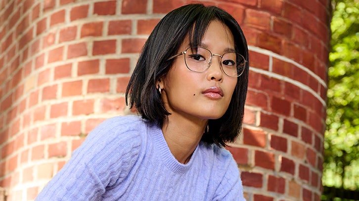 Model wearing yellow shirt and Converese glasses