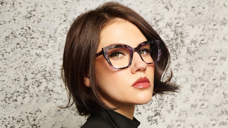 Female model wearing tortoiseshell bebe cat-eye eyeglasses