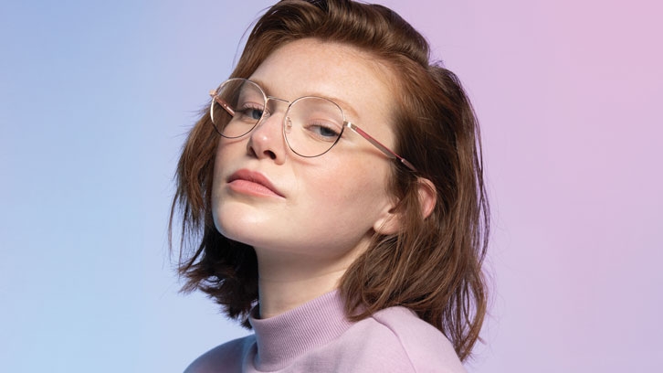 Model wearing yellow shirt and Converese glasses