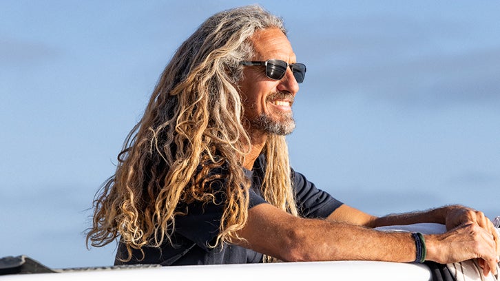 Man with long hair wearing black Dragon sunglasses