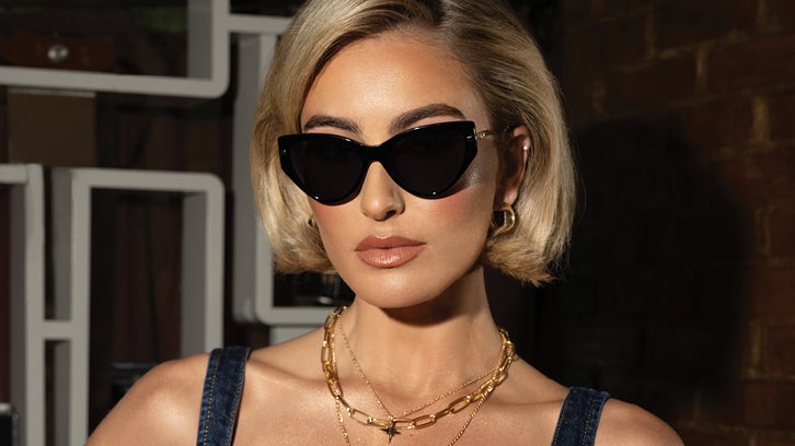 Female model wearing black bebe cat-eye sunglasses